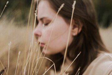 Beautiful portrait of a young stylish woman on a sunny day in autumn.