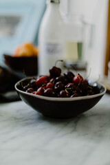 Vertical shot of a bowl of cherries in th