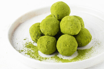 matcha energy balls cut close up top view healthy sweets made from nuts and dates, matcha tea