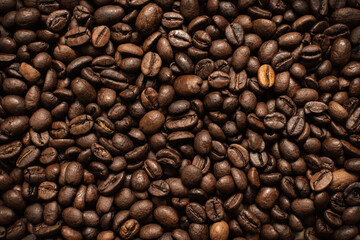 Coffee beans. Coffee beans are spread out on the surface.