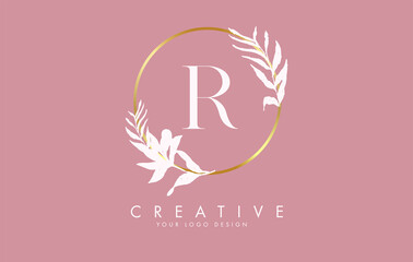 R Letter logo design with golden circle and white leaves on branches around. Vector Illustration with R letter.