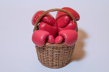 boxing gloves for adults and children in a wicker basket on a white background