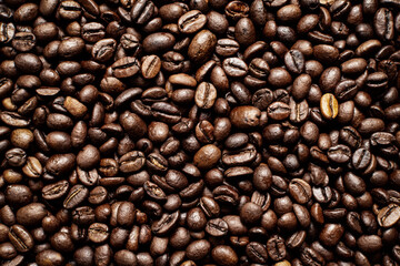 Coffee beans. Coffee beans are spread out on the surface.