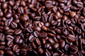 Fototapeta premium Roasted coffee beans, top view of coffee beans. Roasted coffee beans background