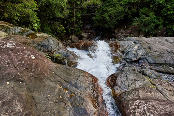 Naklejka na ściany i meble Small waterfall in Sri Lanka hills