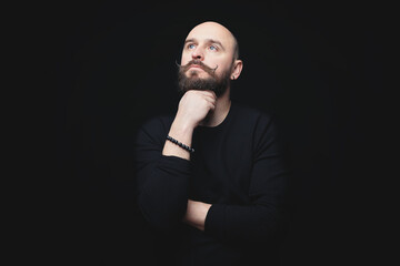 portrait of a man with a beard on a dark background