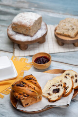 Varieties of nutritious bread with butter 
marmalade and cinnamon on blue wooden background