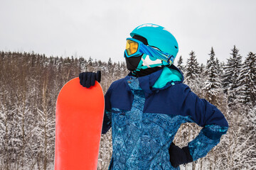 Person with a snowboard on the ski resort
