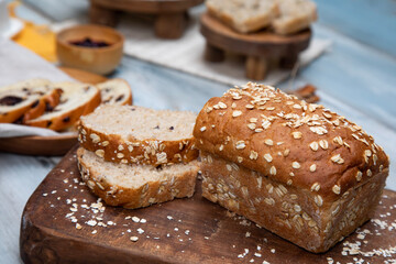 Chopped oat bread on a wooden and stone background with blackberry jam