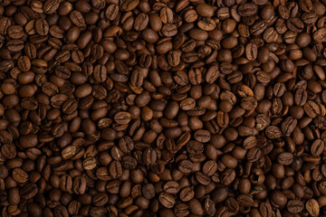Fragrant grains of fried coffee. Background, texture