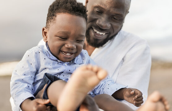 Happy african father with little son outdoor - Black parent enjoy day with toddler - Family love