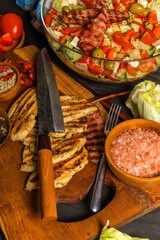 Vegetable salad with chicken and bacon. Salad with tomatoes and cheese. Diet food. Chicken steak with vegetables.