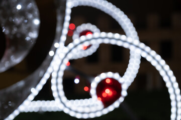 Blurred lights of christmas installation - defocused lights of santa sleigh on night city...