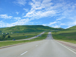 Interstate highway with rolling mountains in South Dakota.