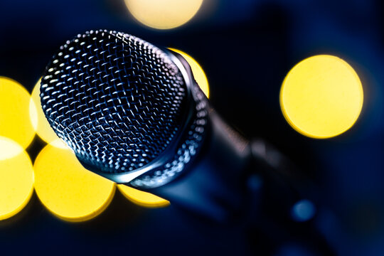 Close-up of microphone and stage lights