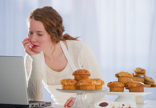 Woman baking and reading recipe