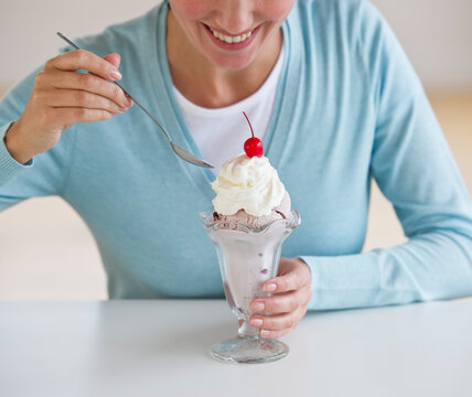 Woman eating ice cream sundae
