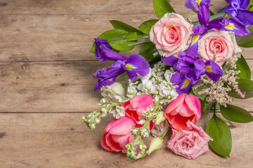 A beautiful bouquet of wedding flowers on old wooden boards