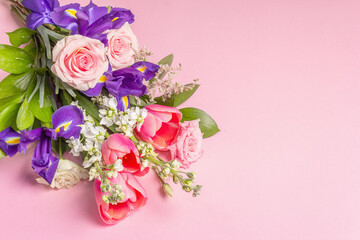 A beautiful bouquet of fresh flowers on a pink pastel background