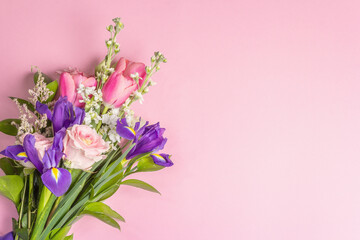 A beautiful bouquet of fresh flowers on a pink pastel background