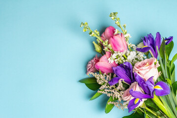 A beautiful bouquet of fresh flowers on a blue pastel background