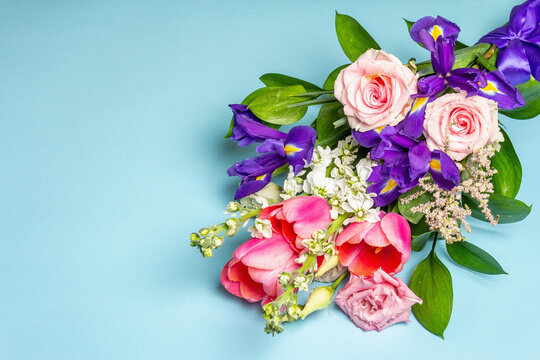 A beautiful bouquet of fresh flowers on a blue pastel background