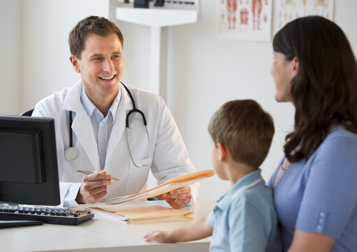 Doctor talking to woman and her son