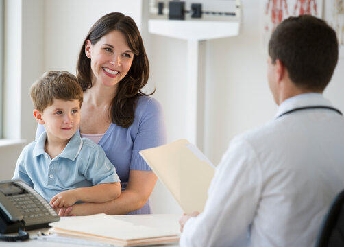 Doctor talking to woman and her son