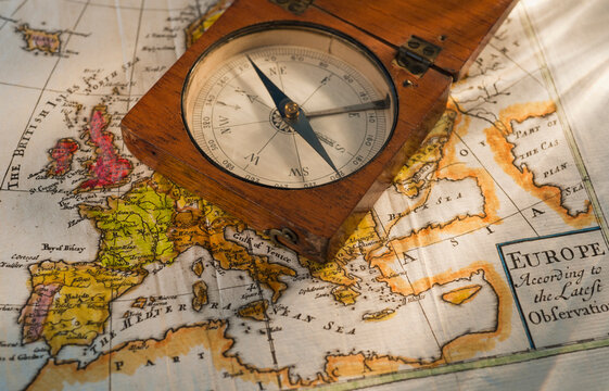 Antique compass on map