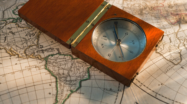 Antique compass on map