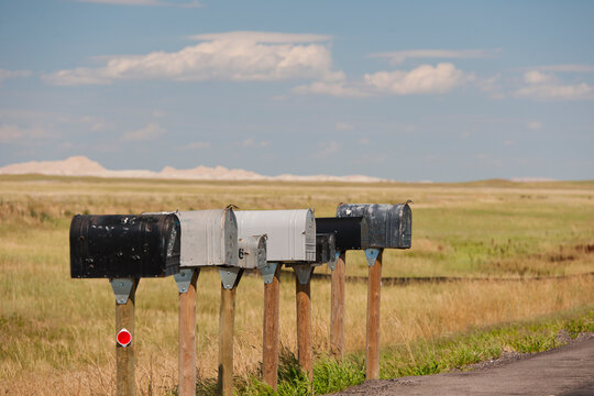 USA, South Dakota, Row of rural mailboxes on roadside in Buffalo Gap National Grasslands