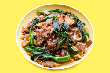 Stir fried flat noodle and pork with soy sauce.