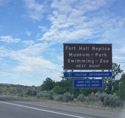 Roadside sign along the highway with directions to Fort Hall Replica Museum and Zoo in Idaho, USA.