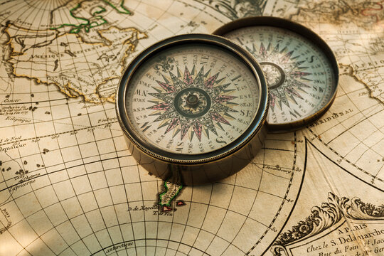 Antique compass on map
