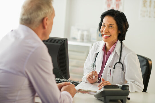 Mature man talking to female doctor