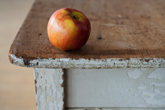 Apple on the egde of table