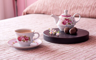 cup of tea and teapot in bed room