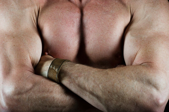 Shirtless muscular man with his arms crossed
