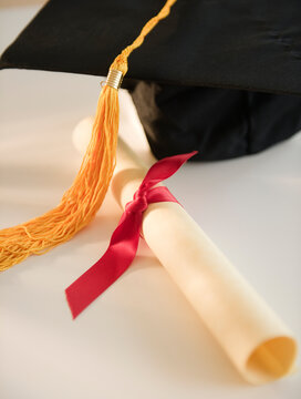 Close Up Of Rolled Diploma And Mortarboard