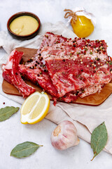 Raw pork ribs, fresh meat with mustard sauce and lemon, top view, flat lay, copy space