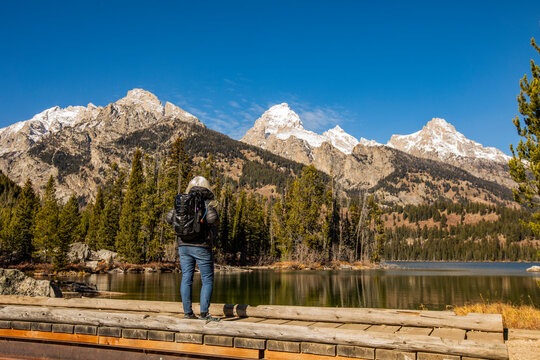 USA, Wyoming, Jackson, Grand Teton National Park, Senior woman standing by Taggart Lake in Grand Teton National Park
