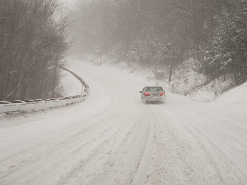 Car on country road in blizzard