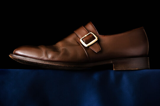Traditional Buckle shoe on black background