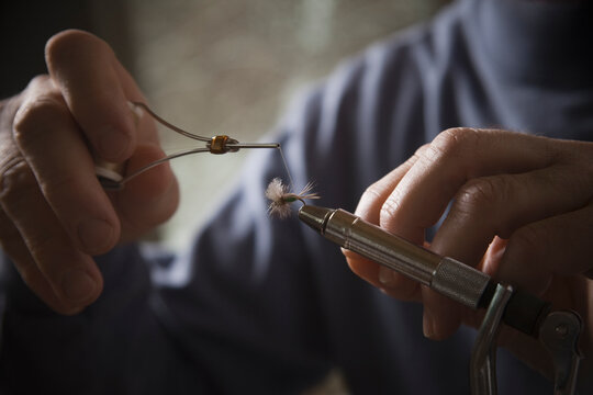 Hands working on fly fishing hook