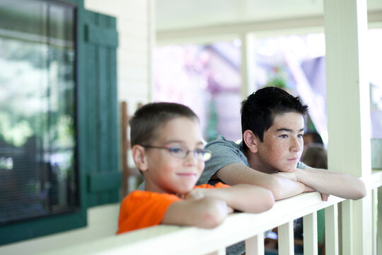 Two young boys gazing over railing