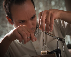 Man repairing fly fishing hook