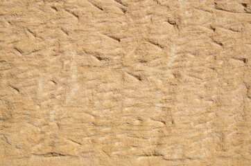 Detailed view of a hand-hewn sandstone as texture or background