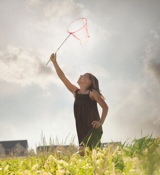 Young girl running with a butterfly net
