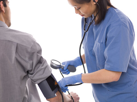 Nurse checking patients blood pressure