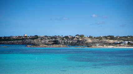 Beach in paradise with transparent water and blue sky.
